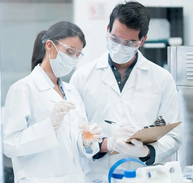 Lab scientists reviewing a sample — Joint Genesis