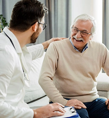 Doctor consulting a smiling older man about Joint Genesis joint support